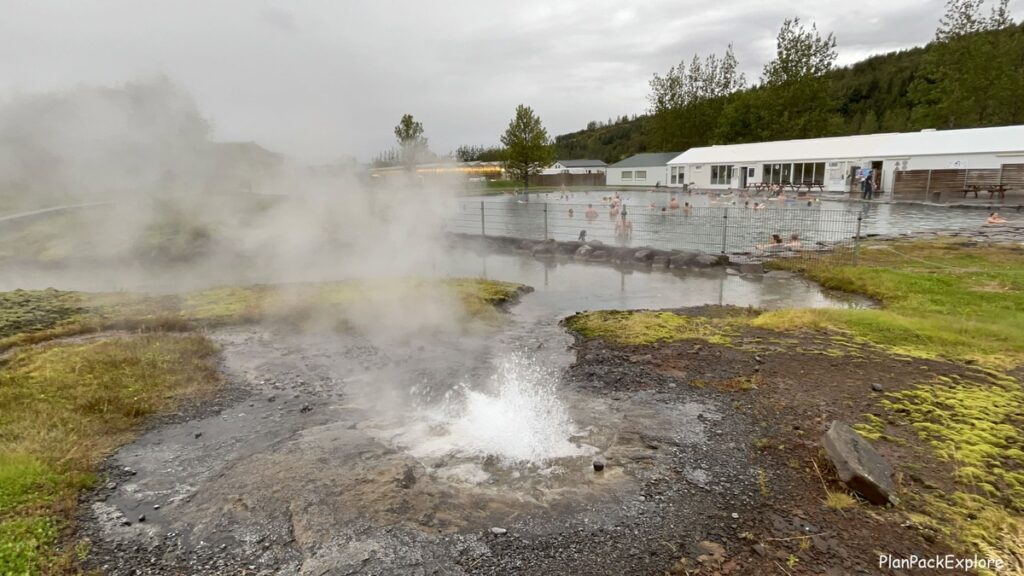 A small geyser erupting around the perimeter of the Secret Lagoon main pool.