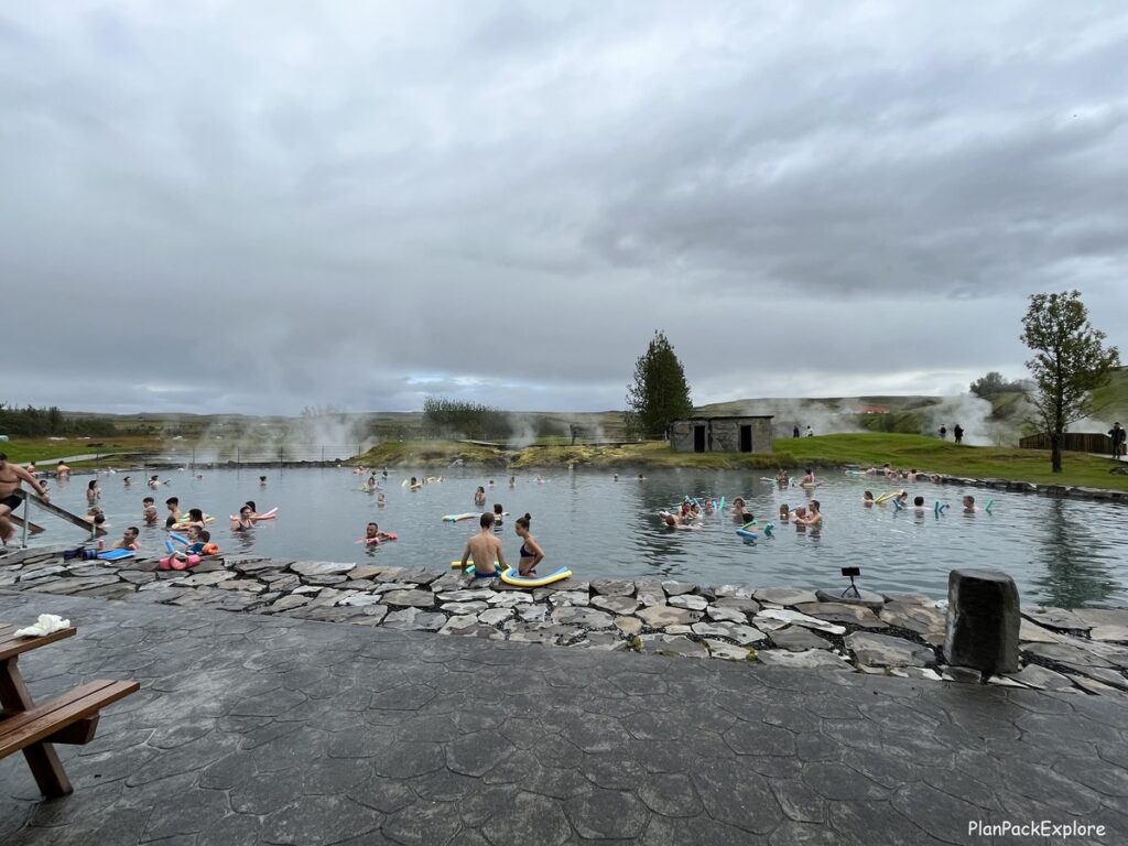 People swimming in Secret Lagoon in Iceland.