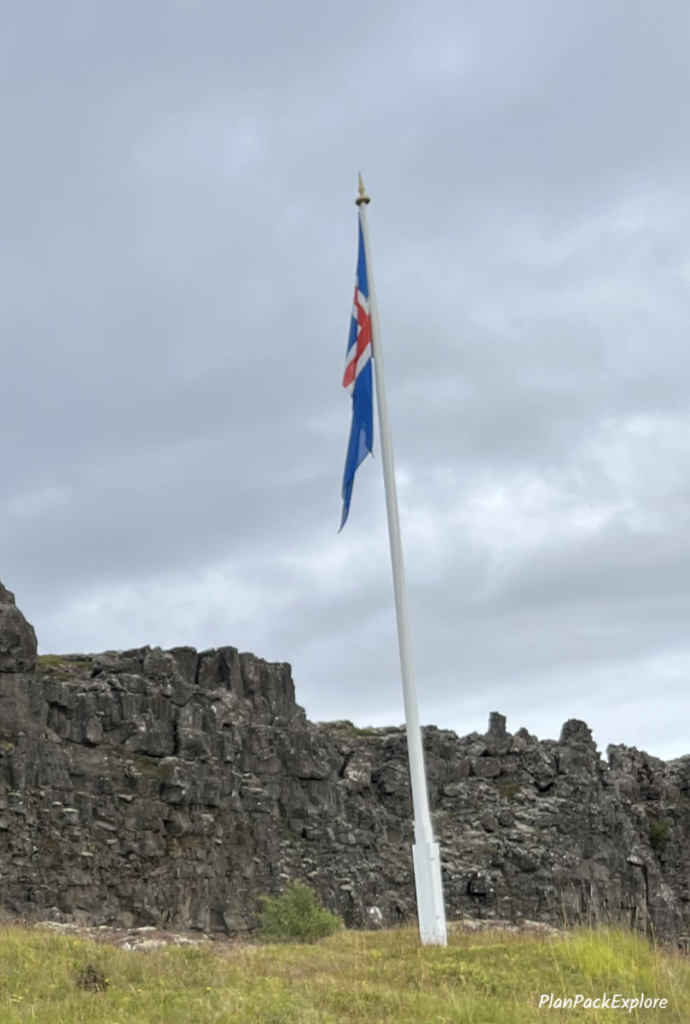 The site of Iceland’s first Parliament, with a viewing platform in front of it, marked with an Icelandic flag. 