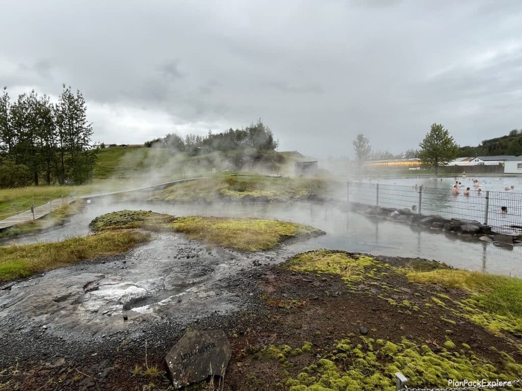 Steaming small geysers around the main pool at Secret Lagoon in Iceland.