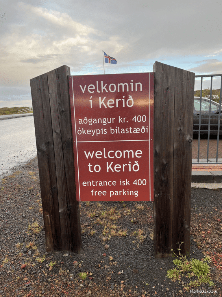 A red sign with white letters stating the fee for Kerid Crater in Iceland.