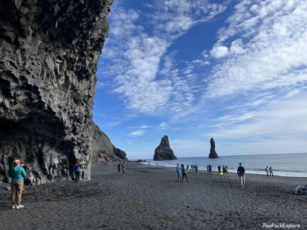 Reynisdrangar basalt sea stacks at Reynisfjara black sand beach in South Iceland.