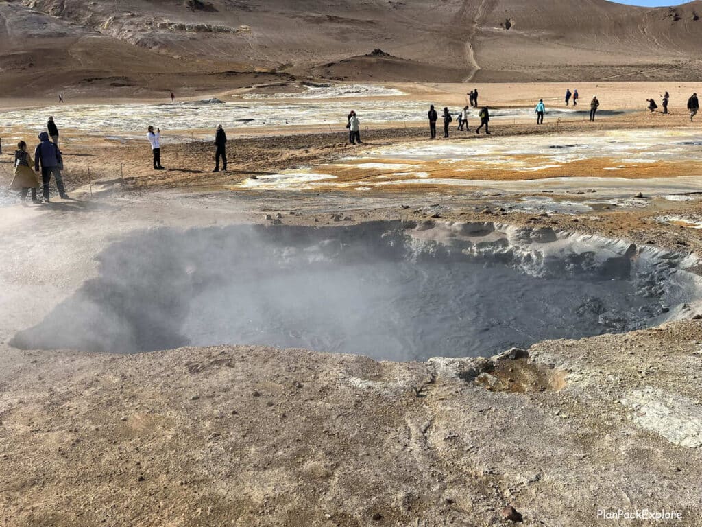 Hverir Geothermal Area and Mt. Namafjall near Lake Myvatn, Iceland. Steaming vents and mud pools in golden colored soil.