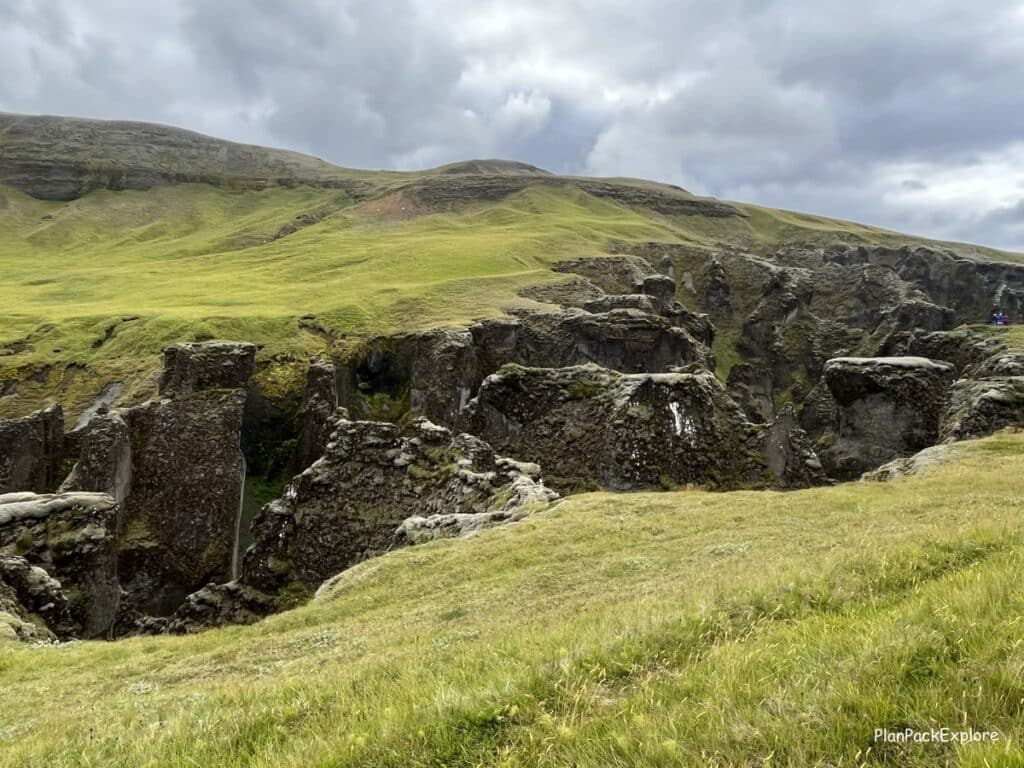 Fjadragljufur Canyon in Southeast Iceland. Moss-covered walls with a river winding at the bottom.
