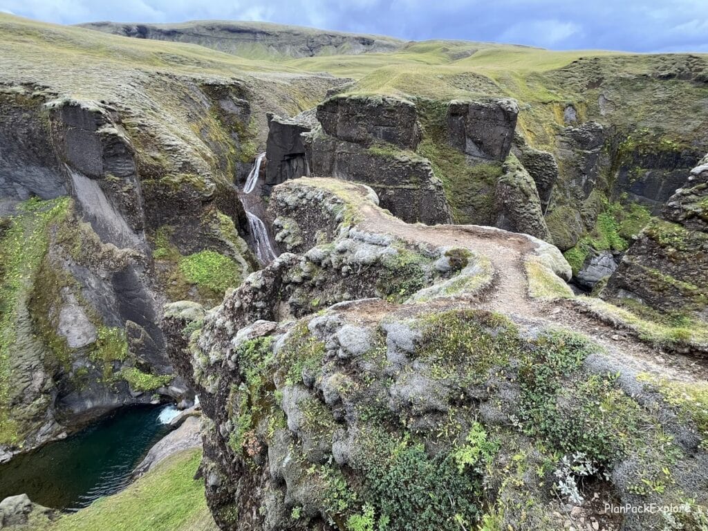 Fjadragljufur Canyon in Southeast Iceland. Moss-covered walls with a river winding at the bottom.
