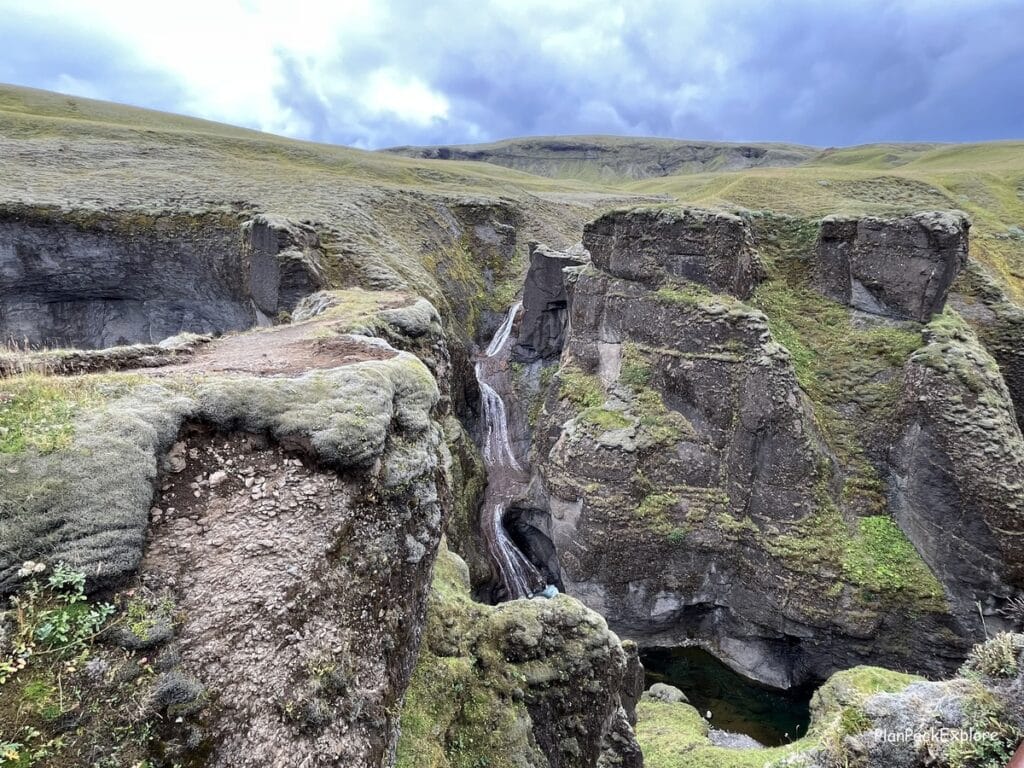Fjadragljufur Canyon in Southeast Iceland. Moss-covered walls with a river winding at the bottom.