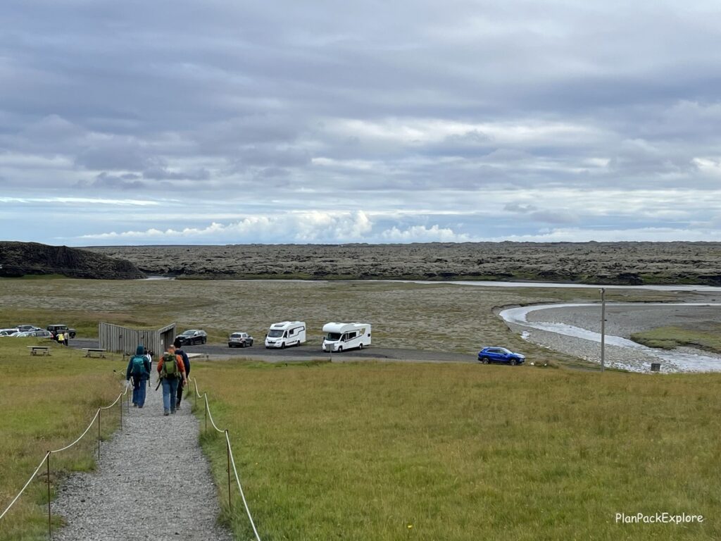 Fjadragljufur Canyon in Southeast Iceland. A A path and the view of the parking lot and the nearby lava field.