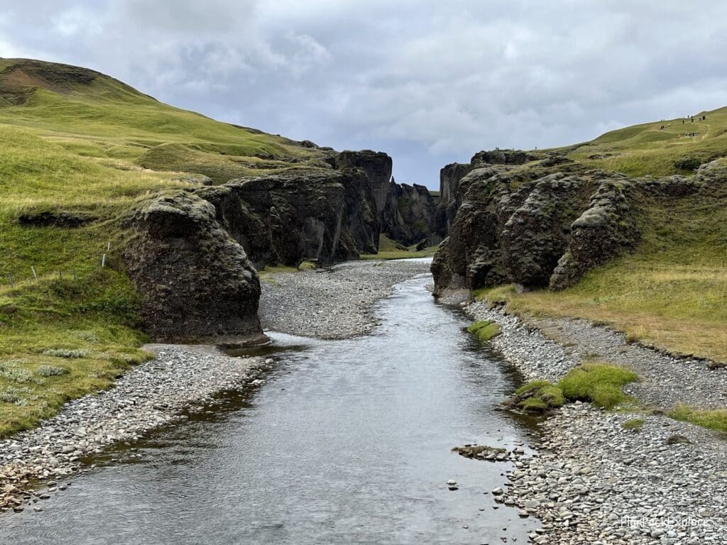 Fjadragljufur Canyon in Southeast Iceland. Moss-covered walls with a river winding at the bottom.
