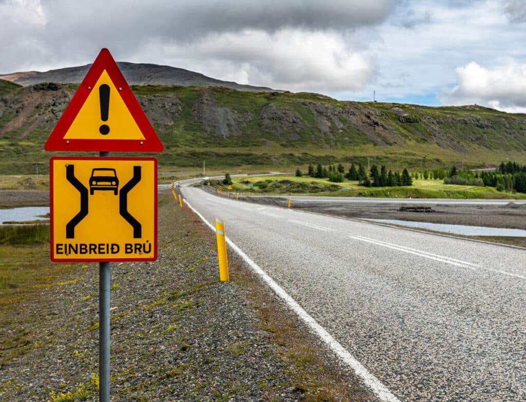 A single-lane bridge road sign in Iceland