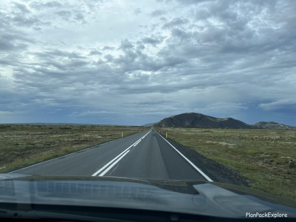 A road in Iceland with a mountain view ahead.