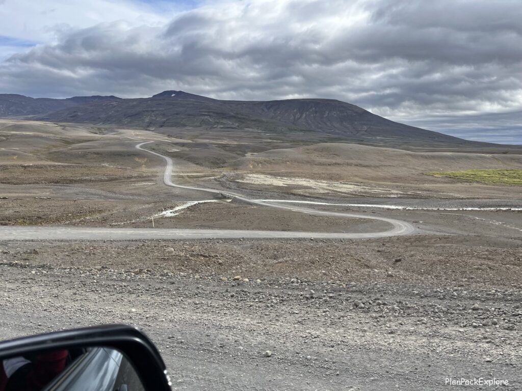 Driving road F35 in the Highlands in Iceland. A winding road with the mountain ahead.