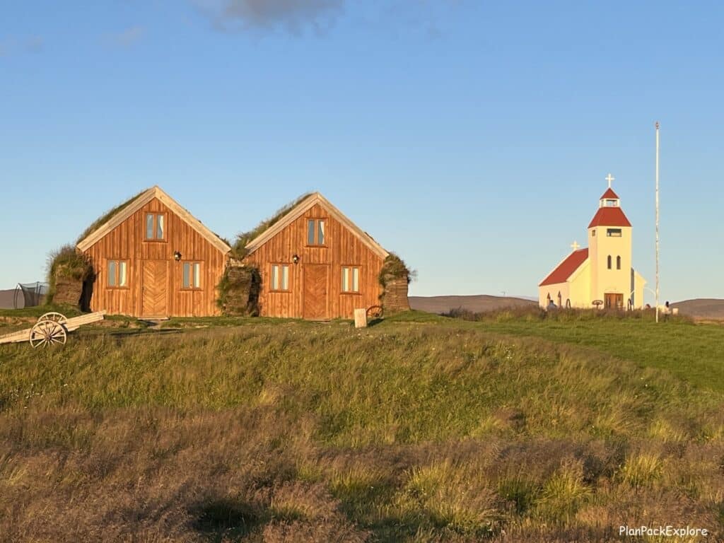 Modrudalur Fjalladyrd farm in Northeast Iceland. Turf houses and a red-roofed church visible in the photo.