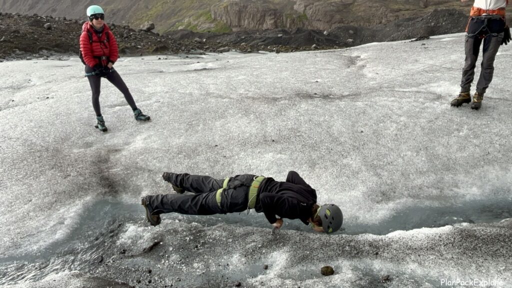 A person doing glacier push-ups on Vatnajokull glacier in Iceland.