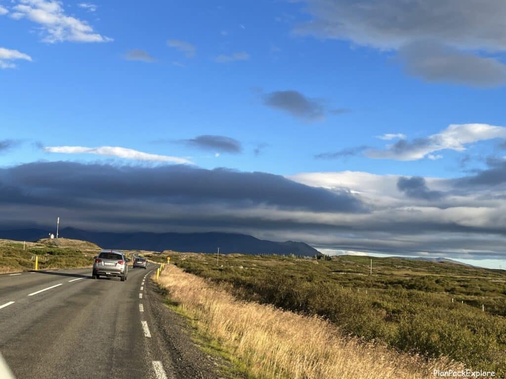 A paved main road in Iceland - view from the windshield of a rental car.