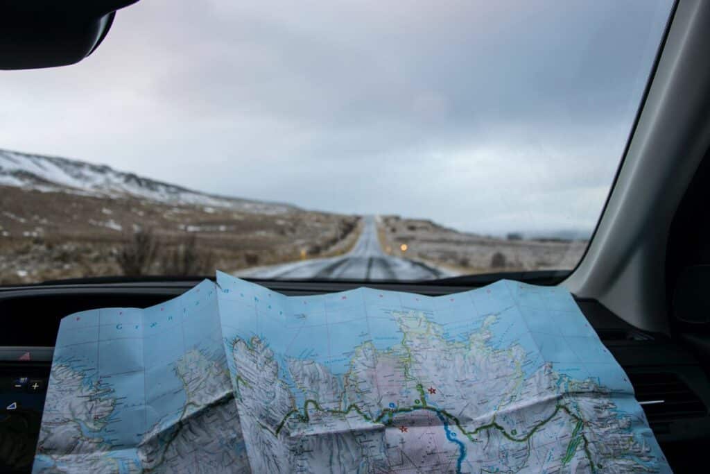 map inside a car with a road ahead in Iceland.