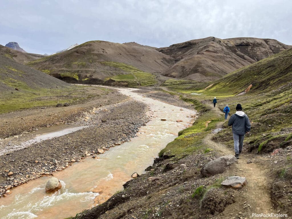 People on the narrow trail by the river leading to Kerlingarfjoll hot spring in Iceland.