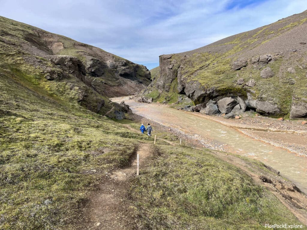 People on the narrow trail by the river leading to Kerlingarfjoll hot spring in Iceland.