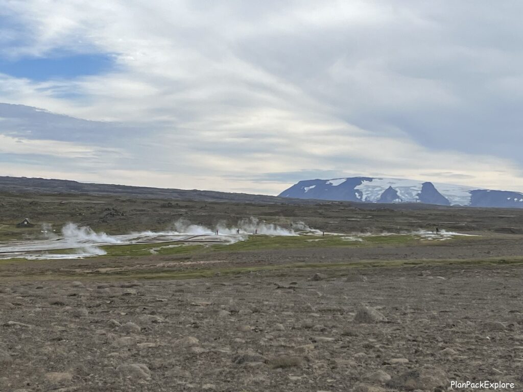 A distant view of a geothermal field of Hveravellir near road F35 in Iceland. Glacier in the bacground.