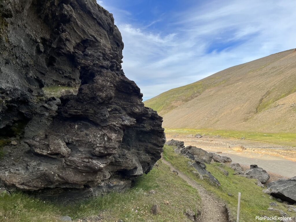 A narrow trail around a large bolder in Kerlingarfjoll, Iceland.