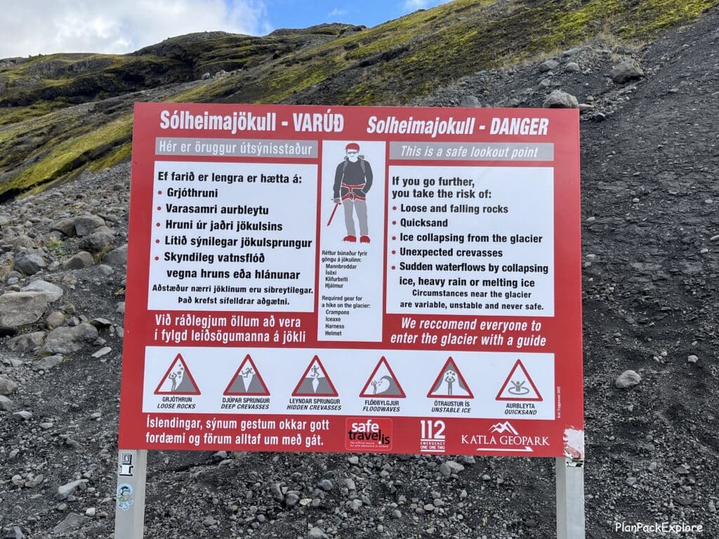 A safety warning sign listing what not to do on glaciers in Iceland. A large red sign with black letters on a white background.