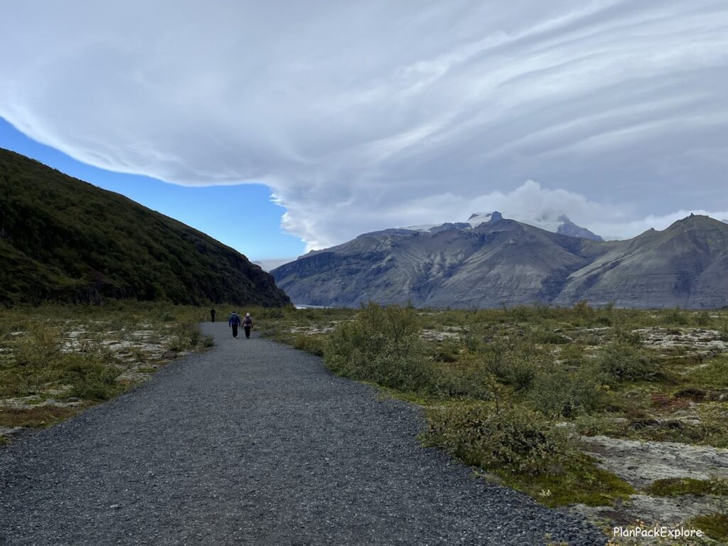 A gravel path leading to Skaftafel glacier in Iceland. A glacier is also visible in the distance.