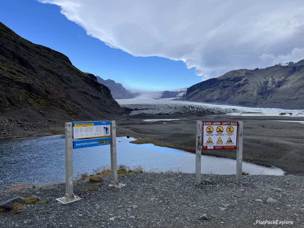 Two large safety warning signs in front of Skaftafellsjokull glacier in Iceland.