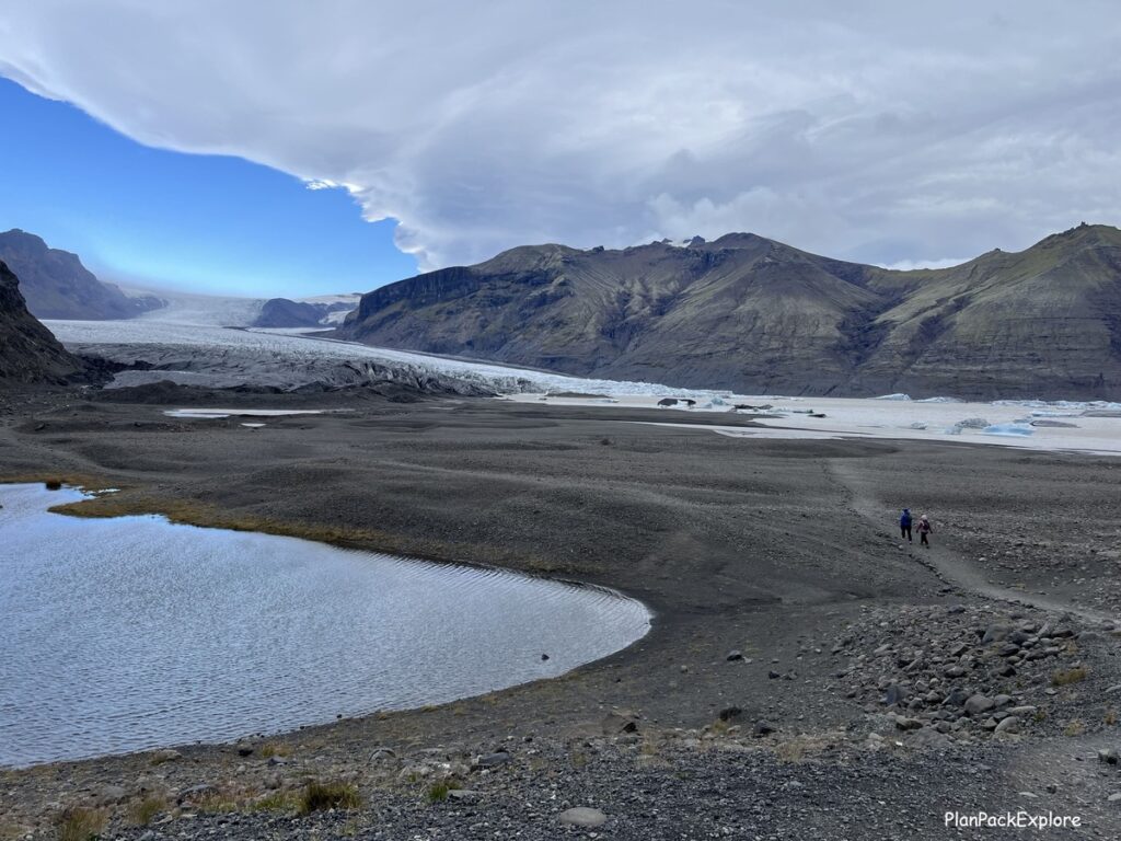 A gravel path leading to Skaftafel glacier in Iceland. A glacier is also visible.