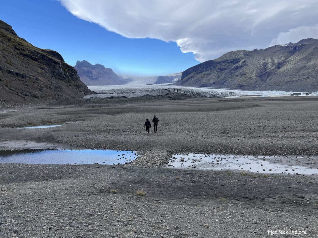 A gravel path leading to Skaftafel glacier in Iceland. A glacier is also visible.