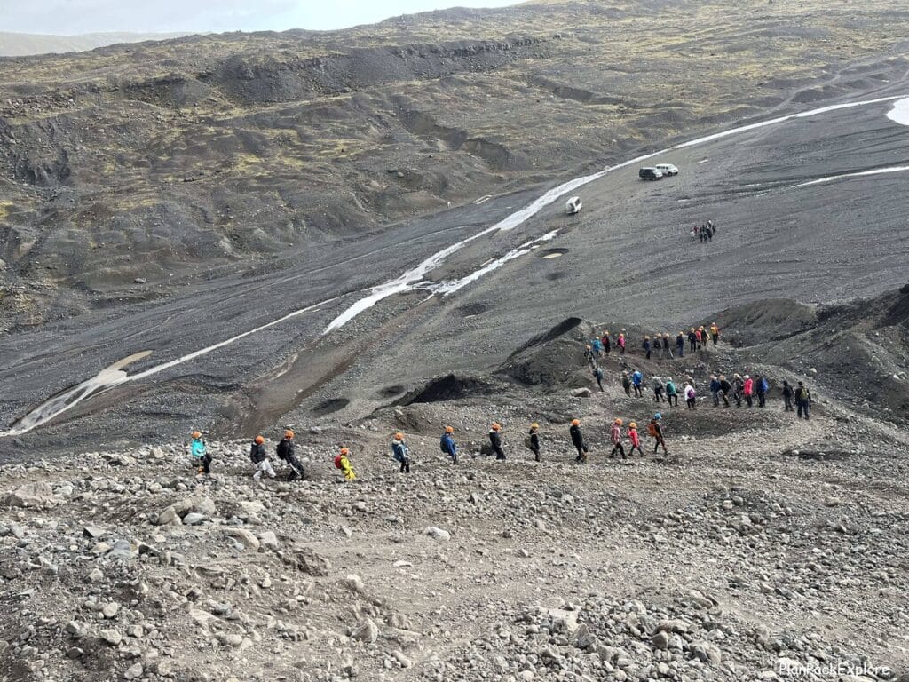 People hiking back down to the base from Vatnajikull glacier ice climbing tour.