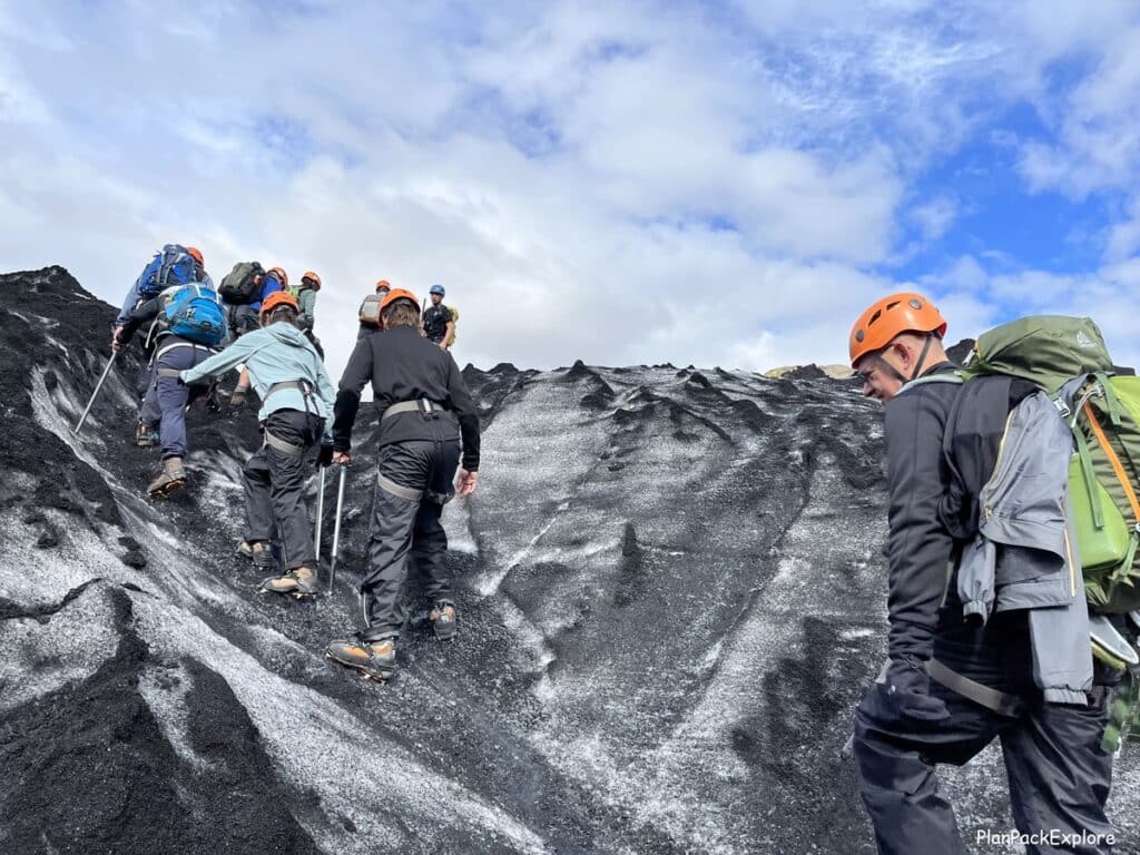 People hiking on Solheimajokull glacier in Iceland.