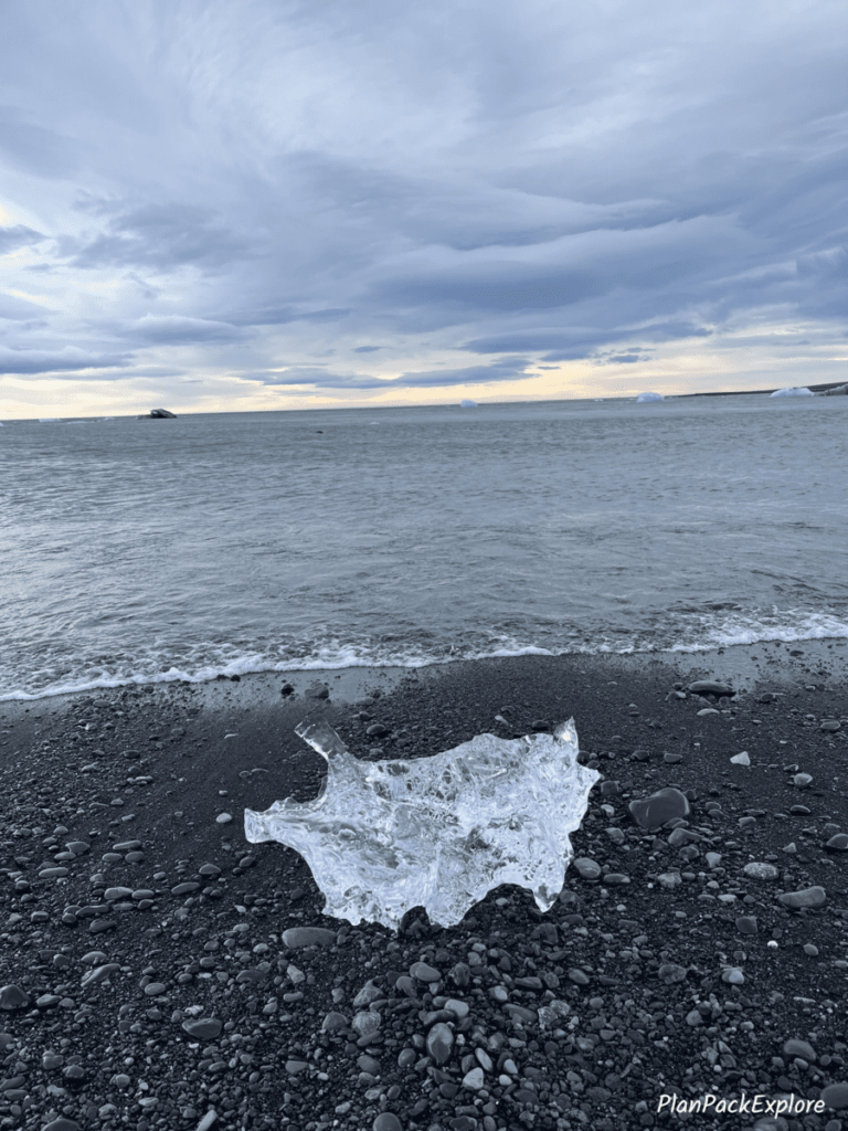 Clear iceberg on the shore of Diamond Beach in Iceland.