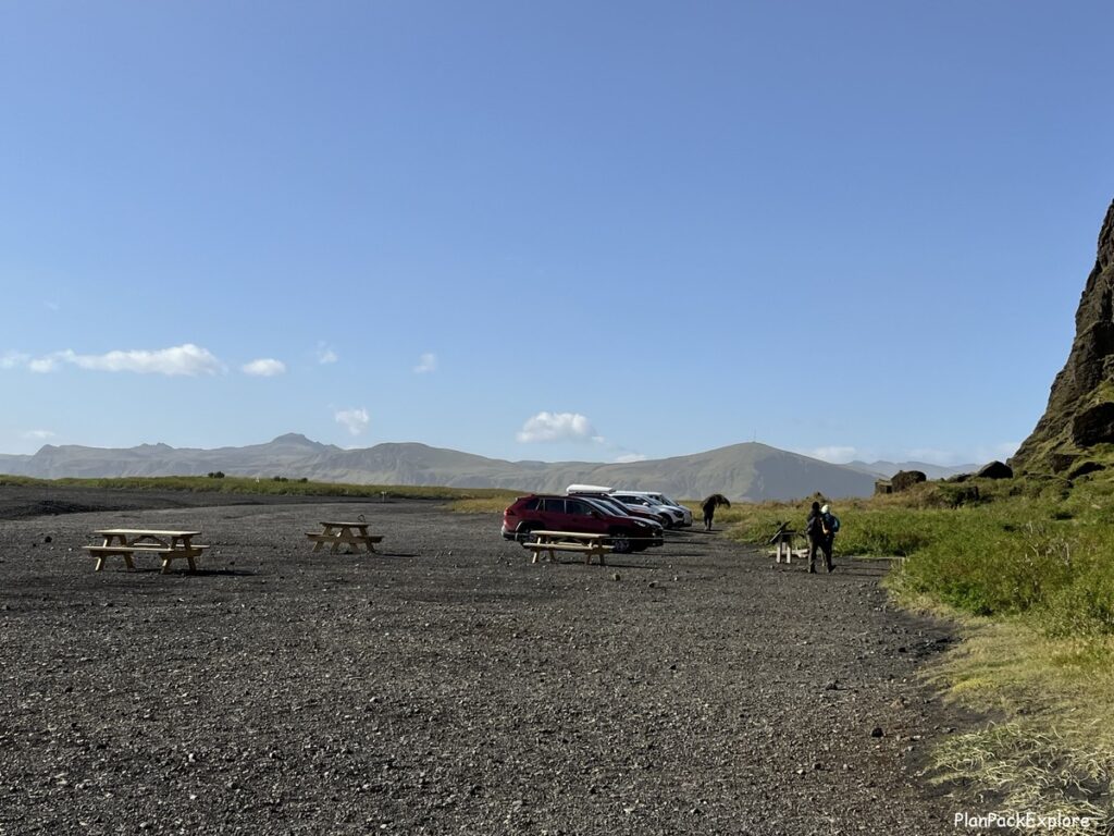 Views of the parking area and picnic tables at the Hjörleifshöfði promontory in Iceland.
