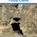 A silhouetted view of Yoda Cave in Iceland, framed by rocky archways that overlook the ocean and sky.