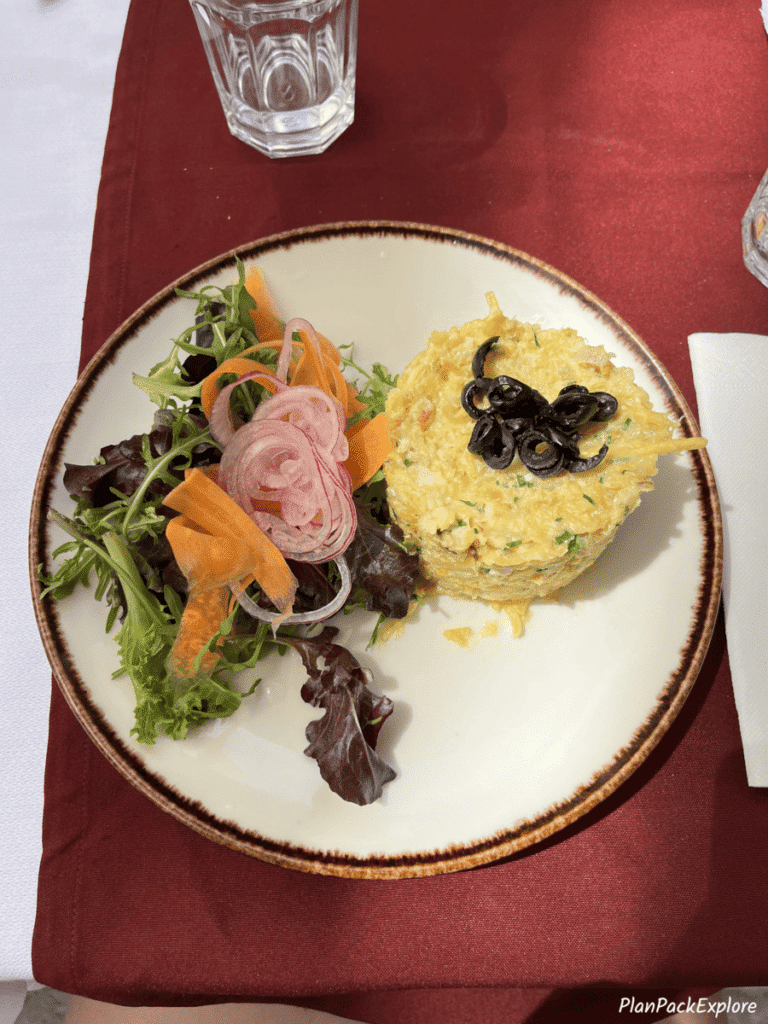 a photo of a plate with a cod cake at a restaurant in Lisbon, Portugal.