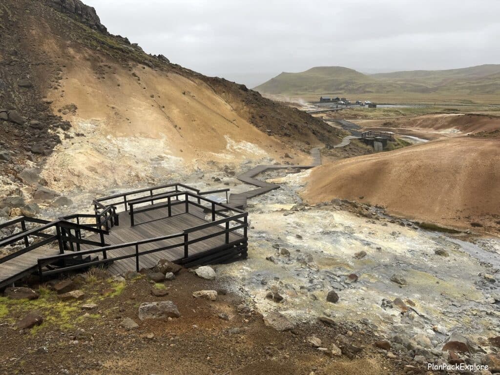 A wooden platform and steaming hot springs at Seltun geothermal area on Reykjanes peninsula in Iceland.