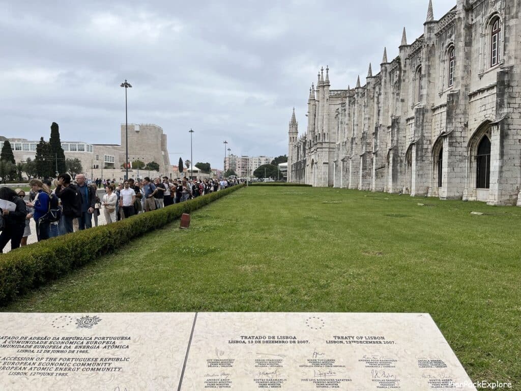 A long line of people waiting in front of Jeronimos Monastery in Lisbon.