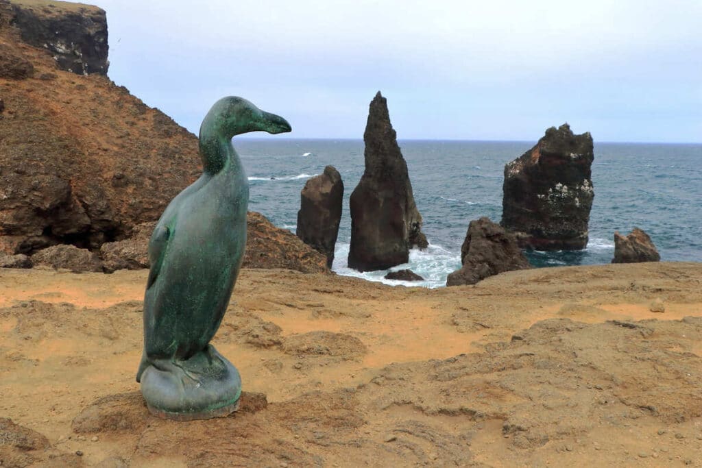 A large bronze sculpture of a great auk at Valahnukamol Cliffs at Reykjanes Peninsula in Iceland.