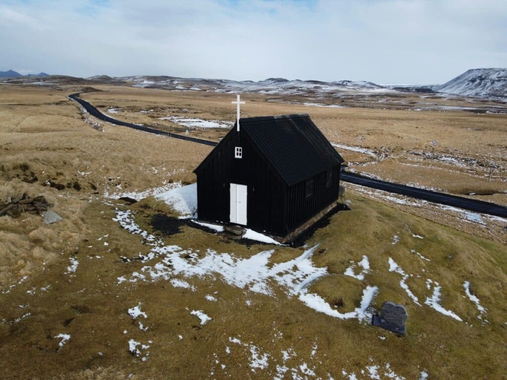 A black church with white door near seltun geothermal area on reykjanes peninsula in Iceland.