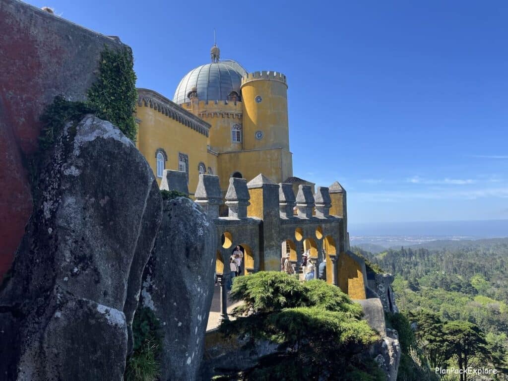 A view of yellow and stone Pena palace towers in Sintra, Portugal.