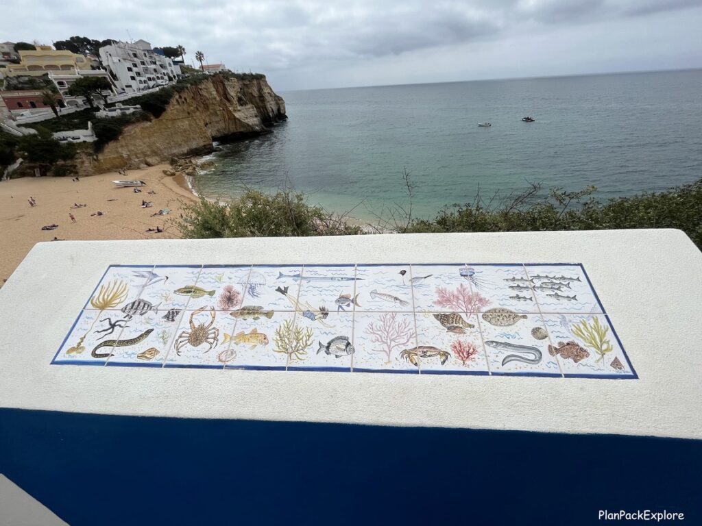 A collage of decorative tiles with a view of a beach in Carvoeiro, Portugal.