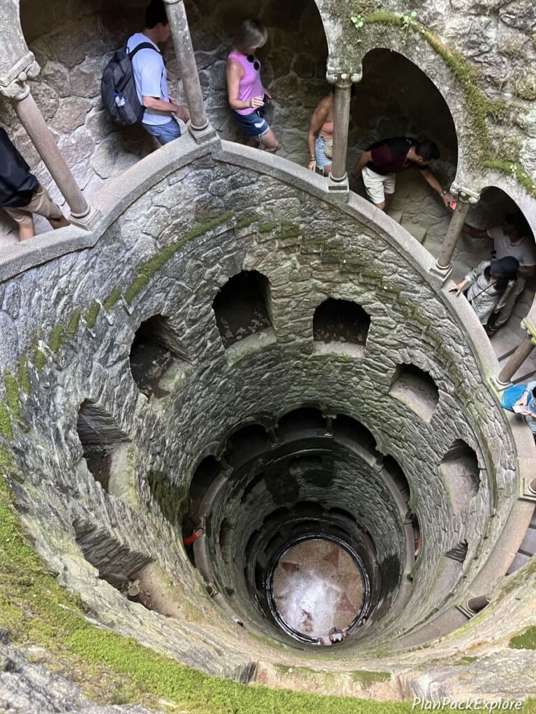A tall round well with arched windows at Quinta da Regaleria in Sintra, Portugal.