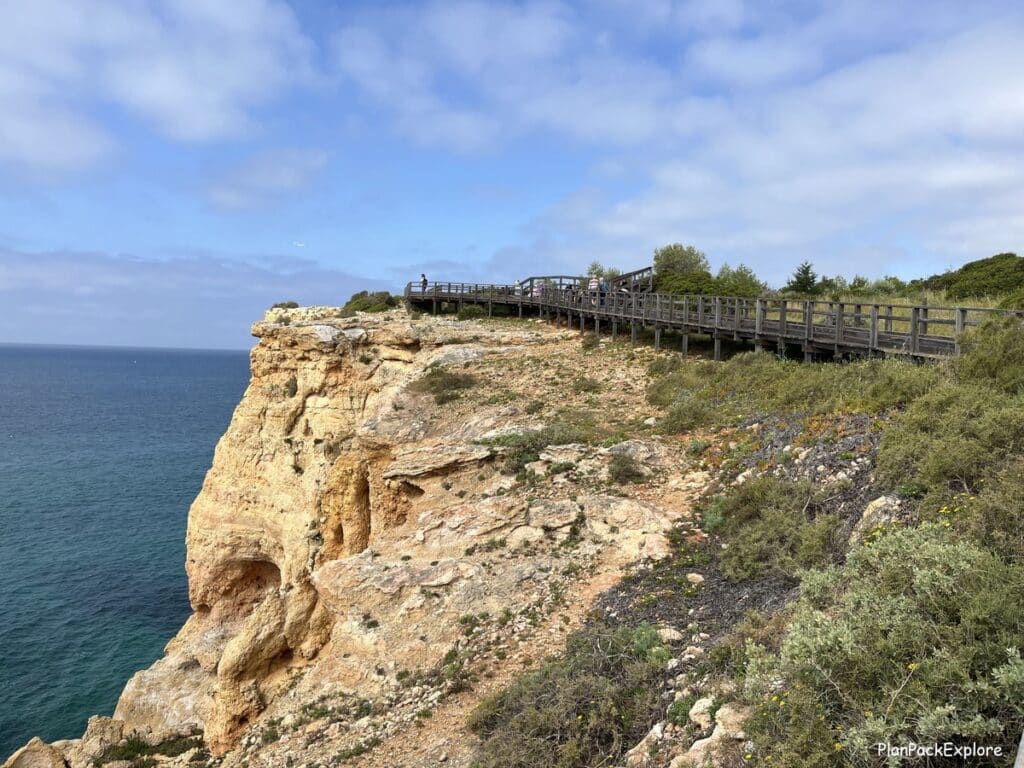 A wooden walkway on top of a cliff at algar seco in the algarve, portugal.