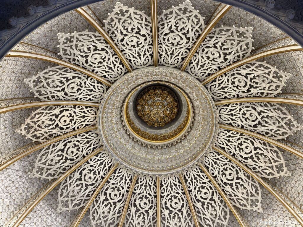 A decorative domed ceiling with carvings, inside monserrate palace in sintra portugal.