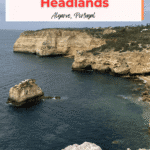 A scenic view of the coastline along the Trail of the Headlands in Algarve, Portugal, featuring prominent cliffs and rock formations by the sea.