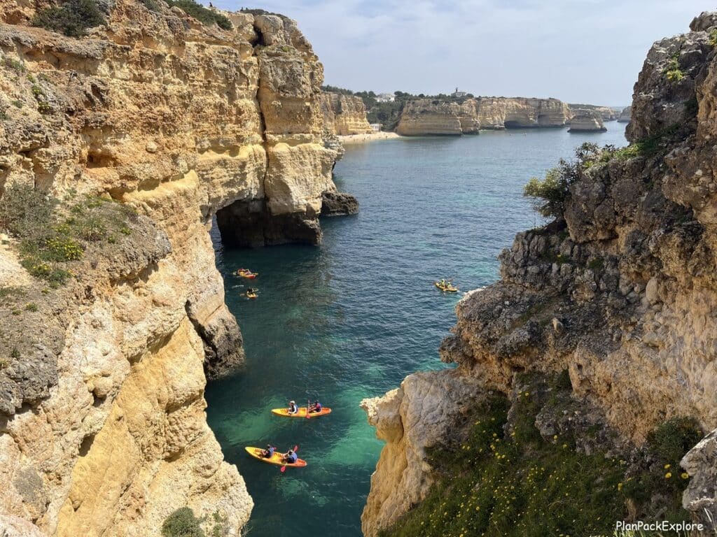 Kayak heading to Benagil cave viewd from the cliffs above in the Algarve, Portugal.