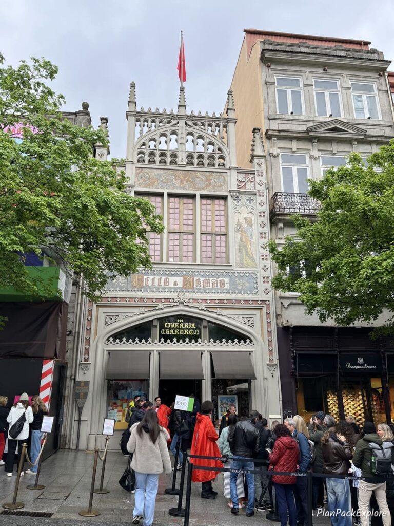 A long line of people waiting to enter Livraria Lello in Porto, Portugal.