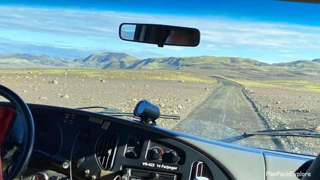 A winding gravel road viewed from the car window leading to laki Craters in Iceland.