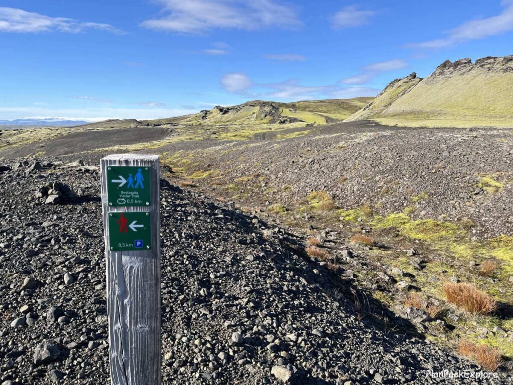 A signpost directing visitors to a trail in a vilcanic crater.