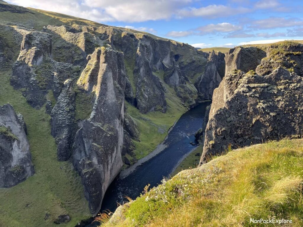 Serpentine shaped walls of a canyon with a river at the bottom (Fjadrargljufur Canyon in Iceland)