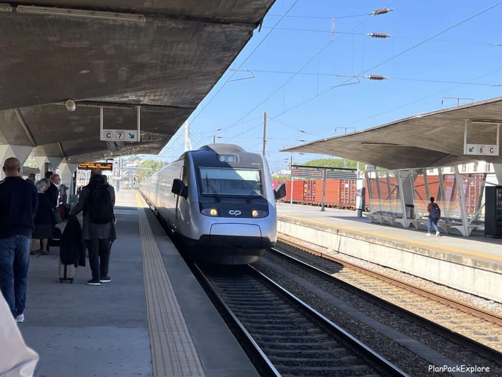 A fast train approaching a platform of a train station in Europe.